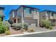 Modern two-story home featuring a two-car garage, desert landscaping, and a neutral color palette at 4160 Elegant Chateau St, Las Vegas, NV 89135