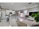 Open-concept living space featuring a kitchen island, comfortable seating, and modern decor at 4160 Elegant Chateau St, Las Vegas, NV 89135