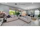 Inviting living room with a large sofa, modern ceiling fan, and ample natural light at 4160 Elegant Chateau St, Las Vegas, NV 89135