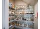 Organized walk-in pantry with shelves stocked with jars of various food items at 4160 Elegant Chateau St, Las Vegas, NV 89135