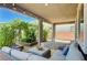 Relaxing covered patio featuring stylish outdoor seating and lush greenery for ultimate comfort and privacy at 4160 Elegant Chateau St, Las Vegas, NV 89135