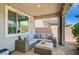 Cozy covered patio with comfortable seating, string lights, and a view of the backyard at 4160 Elegant Chateau St, Las Vegas, NV 89135