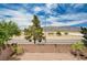 A quaint brick patio surrounded by views of trees and distant mountains against a beautiful blue sky at 4308 Desert Haven Ave, North Las Vegas, NV 89085