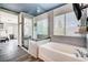 Spa-like bathroom with a glass-enclosed shower, a soaking tub, and stylish tile flooring at 4308 Desert Haven Ave, North Las Vegas, NV 89085