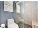 Stylish bathroom featuring a modern toilet and glass-enclosed shower with attractive tile and a built-in bench at 4308 Desert Haven Ave, North Las Vegas, NV 89085