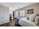 Bright bedroom with wood-look floors, a charming desk area, and decor enhancing the welcoming atmosphere at 4308 Desert Haven Ave, North Las Vegas, NV 89085
