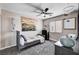 Cozy bedroom with a ceiling fan, a patterned rug, and neutral-toned walls and decor at 4308 Desert Haven Ave, North Las Vegas, NV 89085