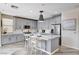 Modern kitchen with gray cabinets, stainless steel appliances, marble countertops and backsplash, and center island with breakfast bar at 4308 Desert Haven Ave, North Las Vegas, NV 89085