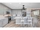 Modern kitchen with gray cabinets, stainless steel appliances, marble countertops and backsplash, and center island with breakfast bar at 4308 Desert Haven Ave, North Las Vegas, NV 89085