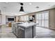 Modern kitchen with gray cabinets, stainless steel appliances, marble countertops and backsplash, and center island with stainless sink at 4308 Desert Haven Ave, North Las Vegas, NV 89085