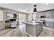 Open-concept kitchen with center island, stainless steel appliances, and gray cabinetry at 4308 Desert Haven Ave, North Las Vegas, NV 89085
