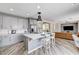 Modern kitchen with gray cabinets, stainless steel appliances, marble countertops and backsplash, and center island with breakfast bar at 4308 Desert Haven Ave, North Las Vegas, NV 89085