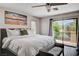 Bright main bedroom with balcony access, scenic views, ceiling fan, and en suite bathroom at 4308 Desert Haven Ave, North Las Vegas, NV 89085