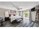 Bright main bedroom with balcony access, scenic views, ceiling fan, and unique dark wood-look flooring at 4308 Desert Haven Ave, North Las Vegas, NV 89085