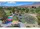 Aerial view of a community playground with colorful play structures, climbing walls, slides, and landscaped surroundings at 4308 Desert Haven Ave, North Las Vegas, NV 89085