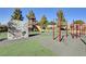 playground featuring a climbing wall, slides, and monkey bars, set on a green and gray surface at 4308 Desert Haven Ave, North Las Vegas, NV 89085