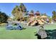 Vibrant playground with slides, climbing equipment, and a car-shaped structure, perfect for outdoor activities at 4308 Desert Haven Ave, North Las Vegas, NV 89085
