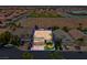 Aerial view of a home with a manicured lawn, mature trees, and a three-car garage, surrounded by other houses at 4326 Spooner Lake Cir, Las Vegas, NV 89147