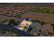 Aerial view of a home showcasing its well-manicured lawn, mature trees, and desert landscaping at 4326 Spooner Lake Cir, Las Vegas, NV 89147