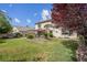 Spacious backyard with green grass, mature trees, patio with pergola and outdoor kitchen at 4326 Spooner Lake Cir, Las Vegas, NV 89147