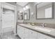 Bathroom with wood floors, double sink vanity with marble countertop, and walk in shower at 4326 Spooner Lake Cir, Las Vegas, NV 89147