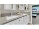 Bathroom featuring double sinks, gray countertops, and white cabinets at 4326 Spooner Lake Cir, Las Vegas, NV 89147
