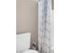 Bathroom featuring a toilet, grey accents, and a white shower at 4326 Spooner Lake Cir, Las Vegas, NV 89147