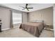 Bedroom features a queen-sized bed, ceiling fan, and neutral color palette at 4326 Spooner Lake Cir, Las Vegas, NV 89147