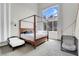 Bright bedroom features a four-poster bed, large windows, and plenty of natural light at 4326 Spooner Lake Cir, Las Vegas, NV 89147