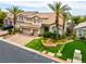 Beautiful two-story home with a well-manicured front yard, palm trees, and a three-car garage at 4326 Spooner Lake Cir, Las Vegas, NV 89147
