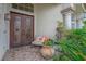 Charming front porch with a decorative front door, a bench, and a water feature at 4326 Spooner Lake Cir, Las Vegas, NV 89147