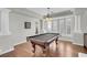Spacious game room with a pool table, elegant columns, and ample natural light at 4326 Spooner Lake Cir, Las Vegas, NV 89147