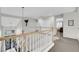 Open hallway features wood railings, hardwood floors, and a contemporary chandelier at 4326 Spooner Lake Cir, Las Vegas, NV 89147