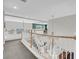 Hallway features white railings, natural light, and a modern light fixture at 4326 Spooner Lake Cir, Las Vegas, NV 89147