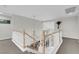 Second floor landing with wood railings and chandelier at 4326 Spooner Lake Cir, Las Vegas, NV 89147