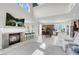 Open floor plan featuring a fireplace, kitchen island, and high ceilings with natural light at 4326 Spooner Lake Cir, Las Vegas, NV 89147