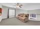 Second-floor loft featuring plush carpeting, ceiling fan, and sitting area at 4326 Spooner Lake Cir, Las Vegas, NV 89147