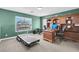 Home office with wooden built-ins, desk, treadmill, and green walls at 4326 Spooner Lake Cir, Las Vegas, NV 89147