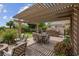 Comfortable outdoor living space with a covered patio, dining table, and built-in outdoor kitchen at 4326 Spooner Lake Cir, Las Vegas, NV 89147