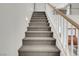 Carpeted staircase leading to the second floor landing with white railings at 4326 Spooner Lake Cir, Las Vegas, NV 89147