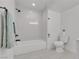 Bright bathroom features a tub with white tile surround, white toilet, and modern fixtures at 4404 Hillcrest Ave, Las Vegas, NV 89102