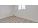 A modern bedroom featuring light wood flooring and a door at 4404 Hillcrest Ave, Las Vegas, NV 89102
