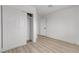 A simple bedroom featuring light wood flooring and a closet at 4404 Hillcrest Ave, Las Vegas, NV 89102