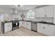 Modern kitchen featuring white cabinets, stainless steel appliances, and a breakfast bar at 4404 Hillcrest Ave, Las Vegas, NV 89102