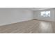 Open-concept living room with new vinyl flooring, ample natural light, fresh paint and a freshly painted white door at 4404 Hillcrest Ave, Las Vegas, NV 89102