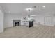 Spacious living area with a modern fireplace, sleek flooring and kitchen in the background at 4404 Hillcrest Ave, Las Vegas, NV 89102