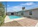 Fenced backyard features a sparkling pool, brick-paver patio, and lush landscaping at 4404 Hillcrest Ave, Las Vegas, NV 89102