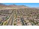 Extensive aerial perspective of a residential neighborhood, highlighted by private swimming pools and stunning mountain views at 465 Cabral Peak St, Las Vegas, NV 89138
