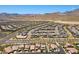 Expansive aerial view of a Primary-planned community near the mountains, showcasing many single Gathering homes and desert landscaping at 465 Cabral Peak St, Las Vegas, NV 89138
