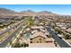 Sprawling aerial image shows a community with well-maintained streets, landscaped yards, and a community pool at 465 Cabral Peak St, Las Vegas, NV 89138